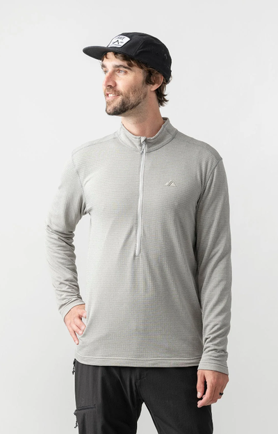 A man wearing frost grey m's basecamp half-zip