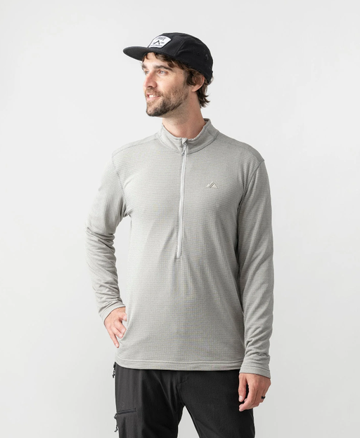 A man wearing frost grey m's basecamp half-zip