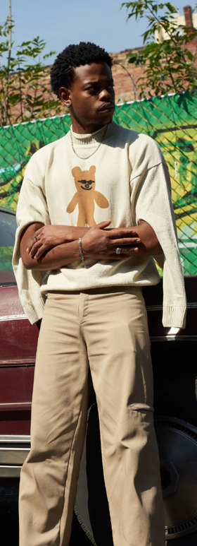 A man wearing sweater with bear design