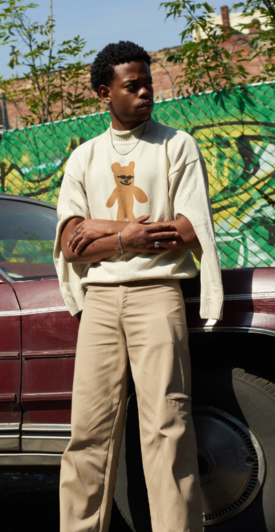A man wearing sweater with bear design