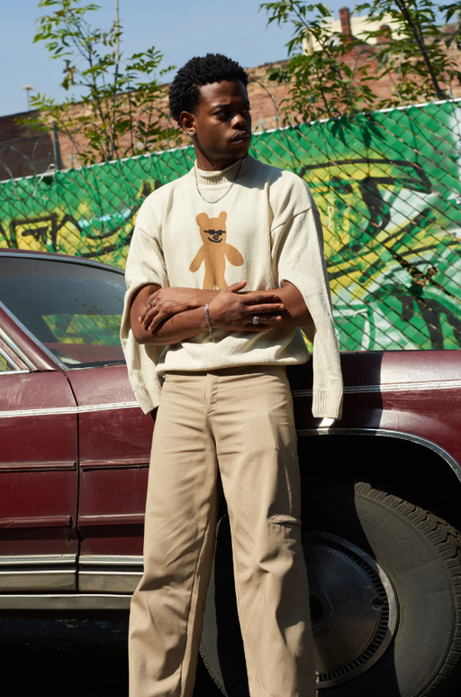 A man wearing sweater with bear design