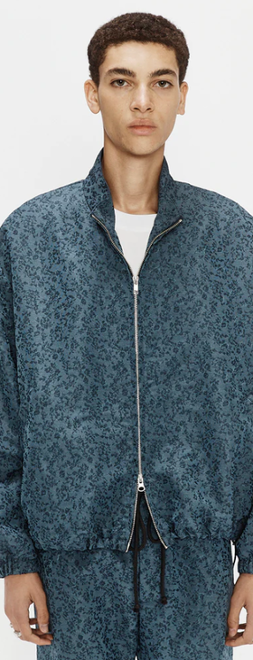 A man wearing blue antique floral lad jacket by Song for the Mute
