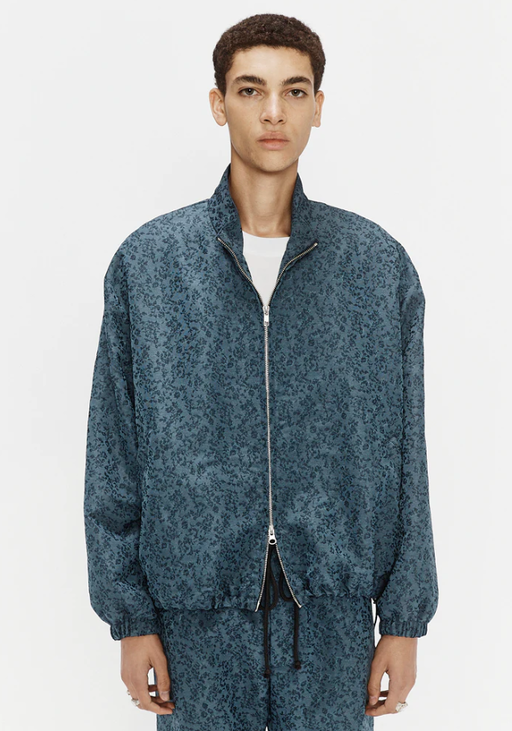A man wearing blue antique floral lad jacket by Song for the Mute