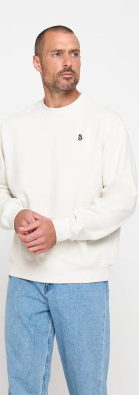 A man wearing birch color sg monogram classic crew pullover