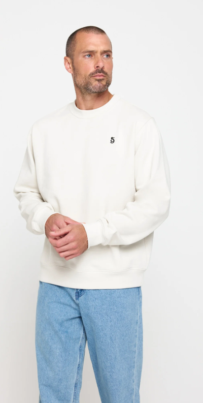 A man wearing birch color sg monogram classic crew pullover