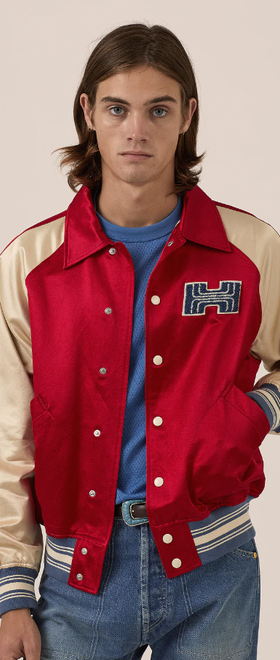A man wearing red varsity jacket
