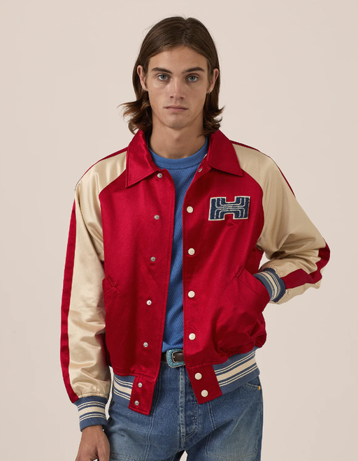 A man wearing red varsity jacket