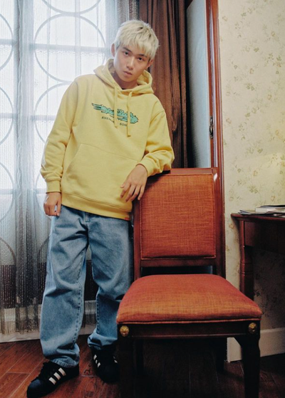 A man wearing yellow hoodie