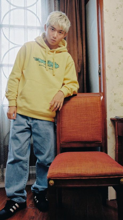 A man wearing yellow hoodie