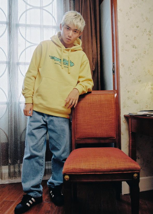 A man wearing yellow hoodie