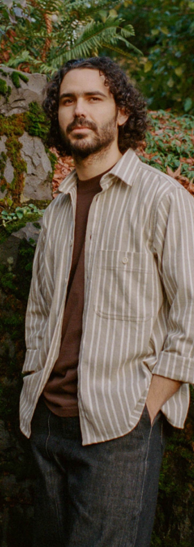 A man wearing pedal-loom woven taupe striped pintor shirt