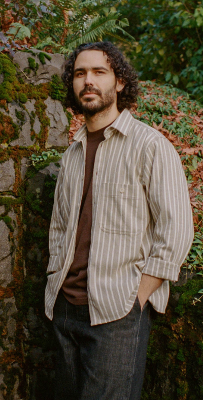 A man wearing pedal-loom woven taupe striped pintor shirt