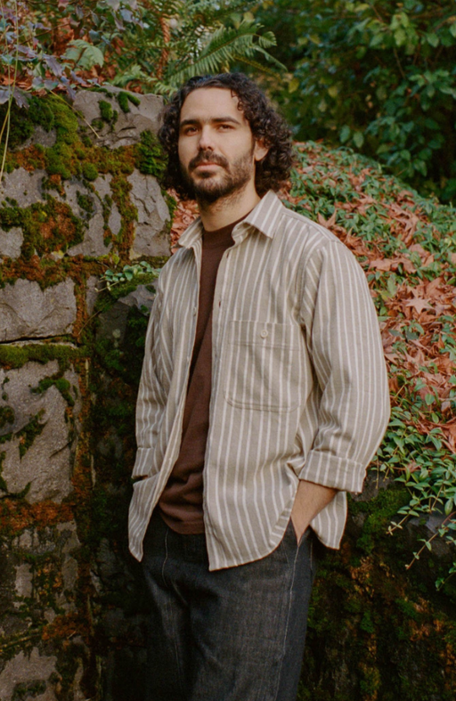 A man wearing pedal-loom woven taupe striped pintor shirt