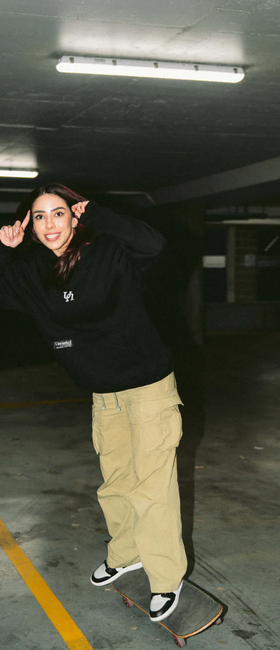 A woman wearing black vol.Ii show hoodie