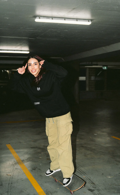 A woman wearing black vol.Ii show hoodie
