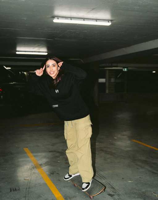 A woman wearing black vol.Ii show hoodie