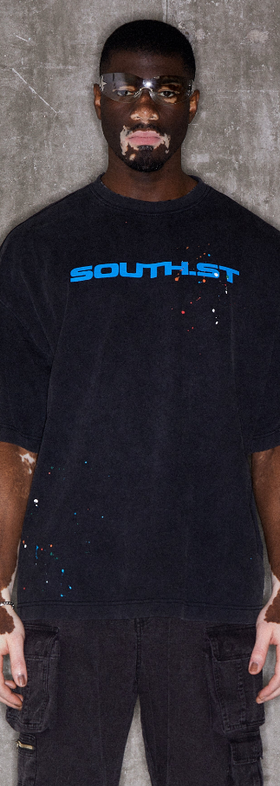 A man wearing black illustrate t-shirt