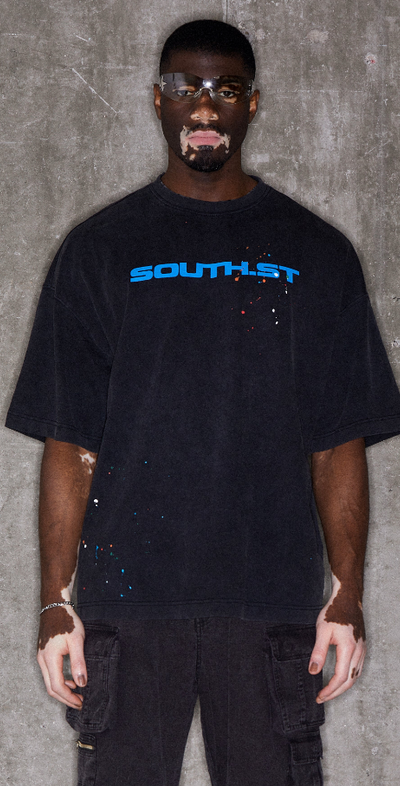 A man wearing black illustrate t-shirt