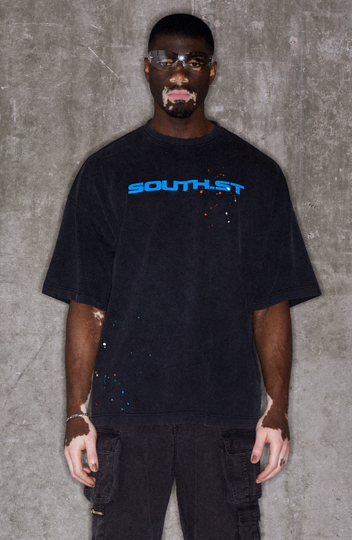 A man wearing black illustrate t-shirt
