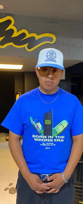 A man wearing blue color born in the wrong era printed t-shirt