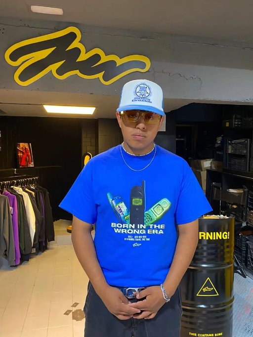 A man wearing blue color born in the wrong era printed t-shirt