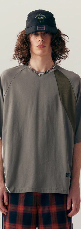 A man wearing grey shattered panel t-shirt