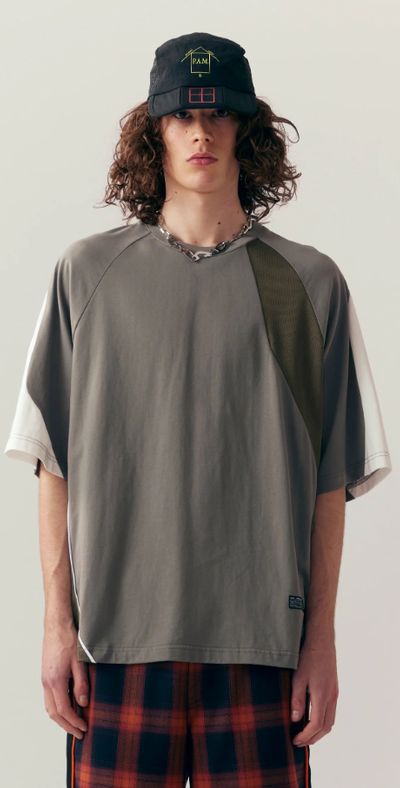 A man wearing grey shattered panel t-shirt