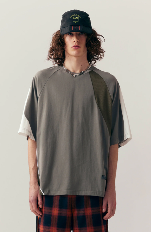 A man wearing grey shattered panel t-shirt