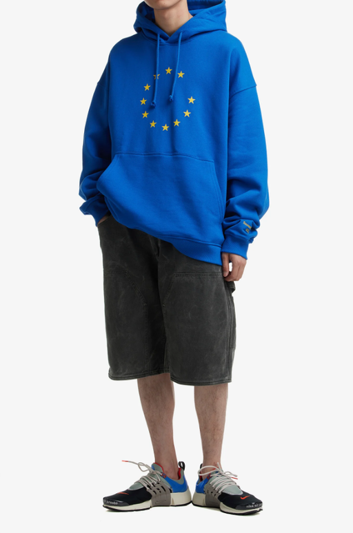 A man wearing eunify blue hoodie
