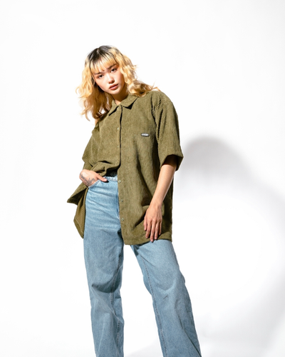 A woman wearing olive jumbo cords shirt
