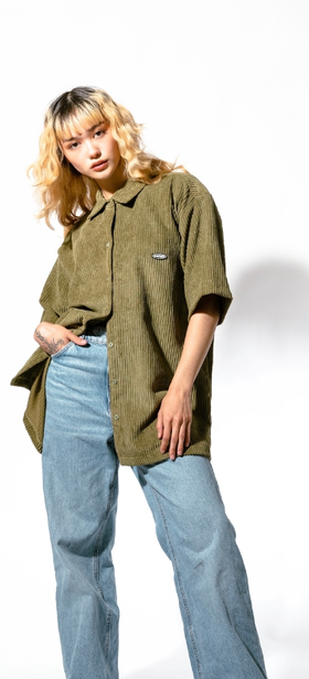 A woman wearing olive jumbo cords shirt