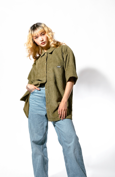 A woman wearing olive jumbo cords shirt