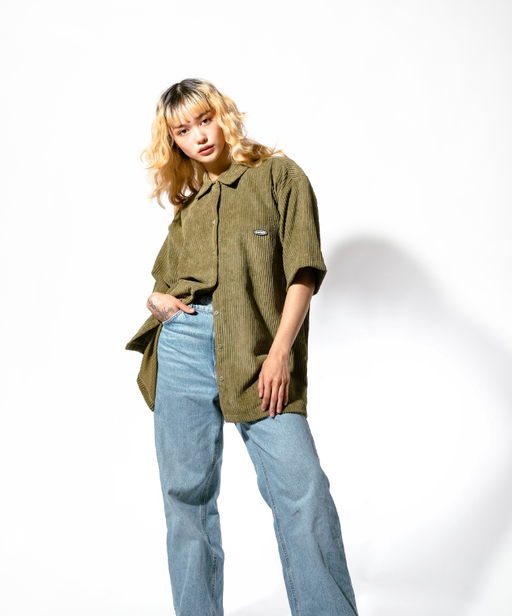 A woman wearing olive jumbo cords shirt