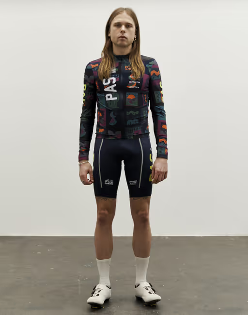 A man wearing multi color stfr mechanism long sleeve jersey