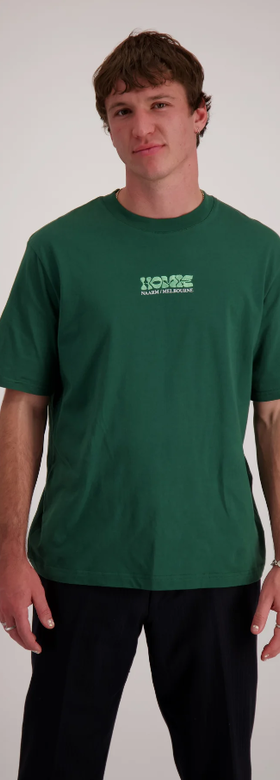 A man wearing homie logo forest green t-shirt