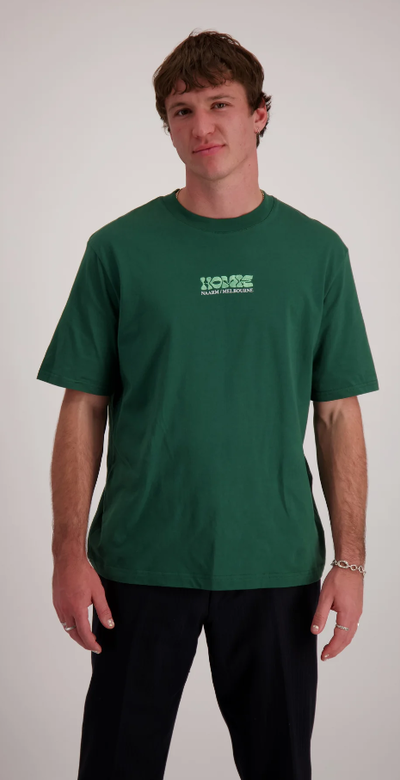 A man wearing homie logo forest green t-shirt