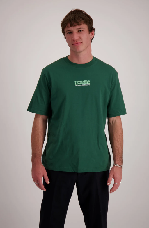 A man wearing homie logo forest green t-shirt