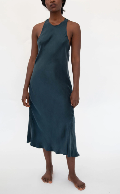 A woman wearing gia sandwashed cupro vegan silk sleep dress