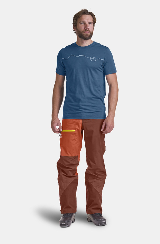 A man wearing mountain blue t-shirt