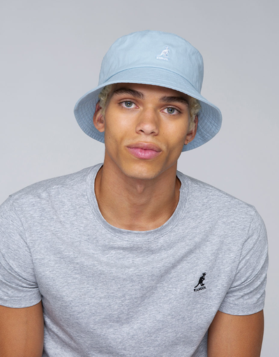 A man wearing a blue washed bucket hat