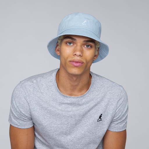 A man wearing a blue washed bucket hat