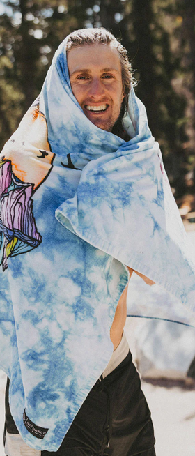 A man wearing chris benchetler beach eco towel