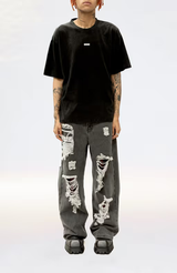 A man wearing a Stolen Girlfriends Club metal hardware tee