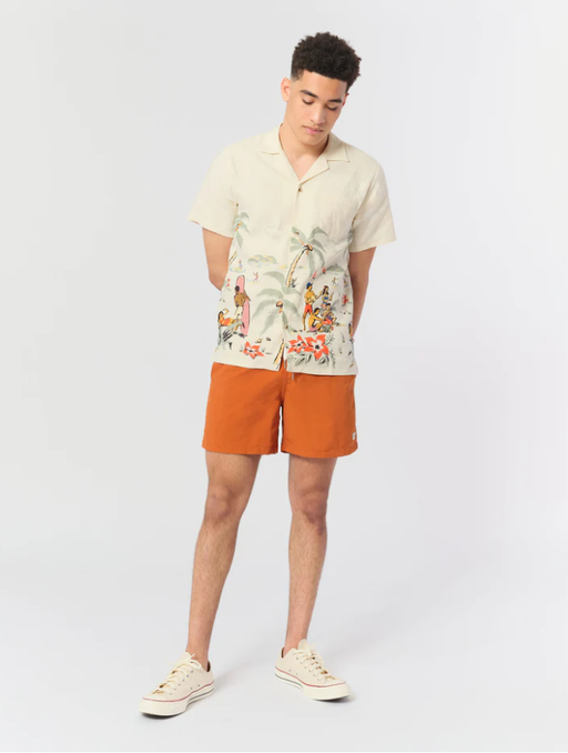 A man wearing a Bather solid ginger swim trunk