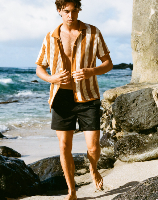 A man wearing the mallorca swim-walk short - onyx