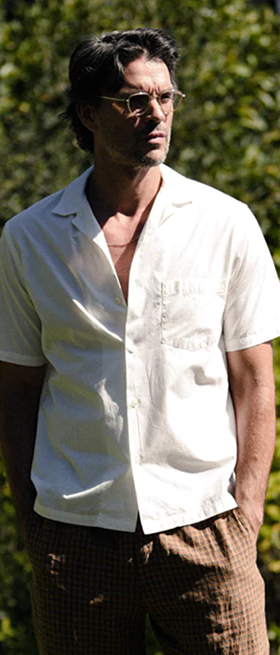 A man wearing a Garrett Leight glasses with a white button up shirt