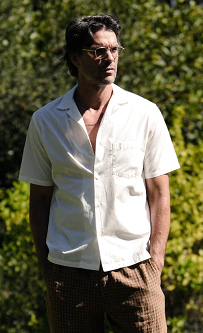 A man wearing a Garrett Leight glasses with a white button up shirt