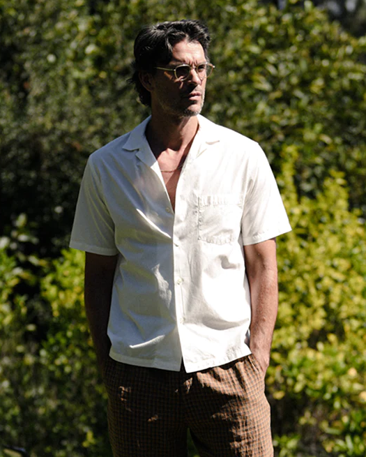 A man wearing a Garrett Leight glasses with a white button up shirt