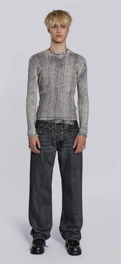 A man wearing a Jaded London black shirt with oversize dark grey jeans
