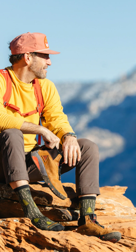 A man wearing a pair of yarn goblin micro crew lightweight Darn Tough hiking sock